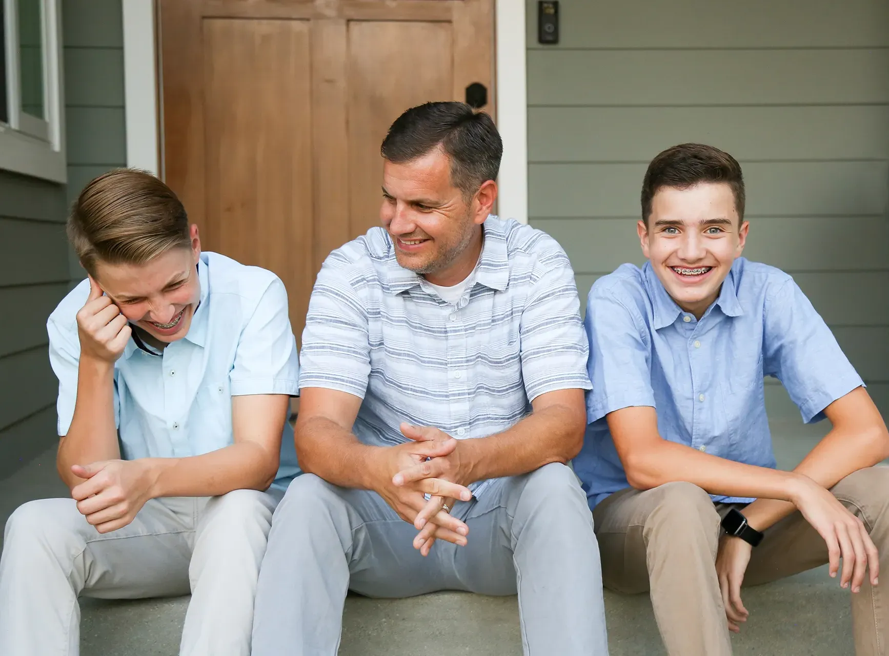 Boys sitting together on a front porch