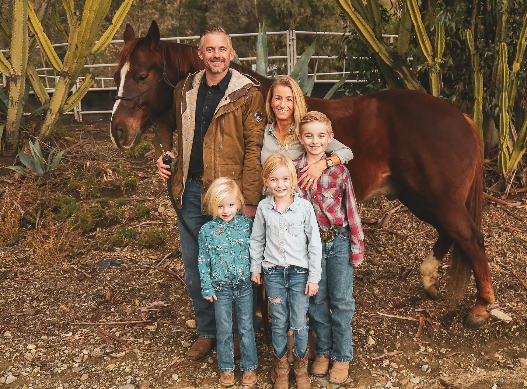 Family portrait with a horse in a landscape setting